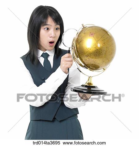 Teens in school unifrom looking at globe with magnifying glass View Large Photo Image Stock Photography - Teens in school unifrom looking at globe with magnifying glass. Fotosearch
