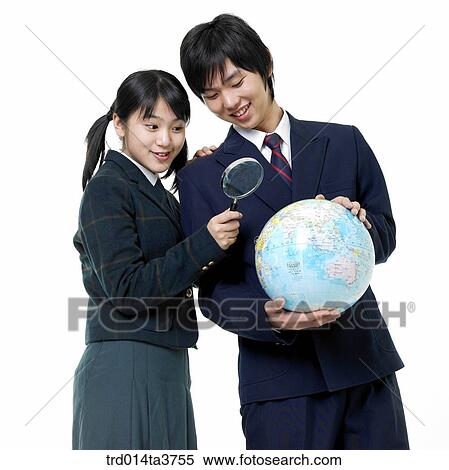 Teens in uniform looking at globe with magnifier View Large Photo Image Stock Photography - Teens in uniform looking at globe with magnifier. Fotosearch