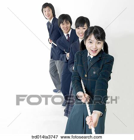 Teens in uniform play at a tug of war View Large Photo Image Stock Photo - Teens in uniform play at a tug of war. Fotosearch