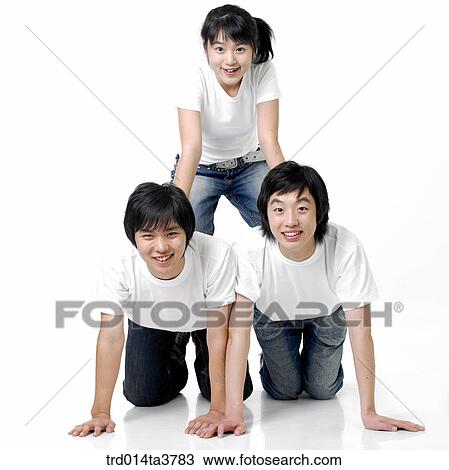 Stock Image - Teens making human pyramid. Fotosearch