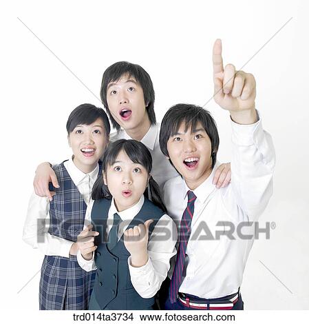 Teens pointing at sky and looking at same direction View Large Photo Image Picture - Teens pointing at sky and looking at same direction. Fotosearch