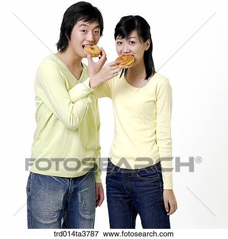 Stock Photo - Teens sharing donuts. Fotosearch