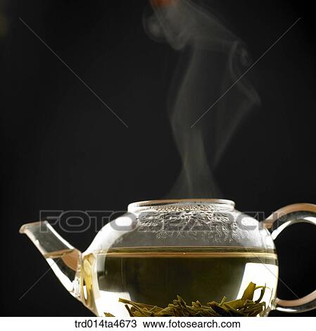 Stock Image - Boiling tea pot and chinese tea, Japanese tea. Fotosearch