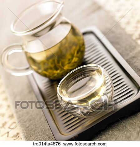 Glass teapot and tea cup on the teatray, art of tea making View Large Photo Image Stock Photograph - Glass teapot and tea cup on the teatray, art of tea making. Fotosearch