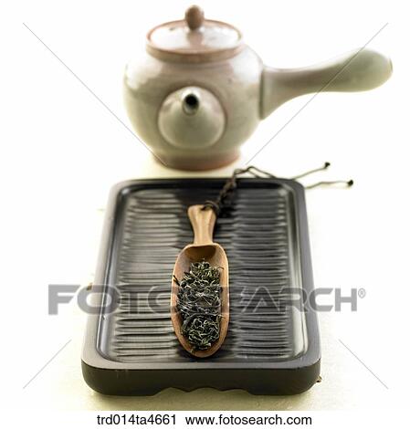 Stock Image - Tea digger and teatray and tea cups, art of tea making . Fotosearch