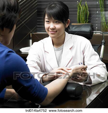 Chinese medicine oriental medicine/ female doctor examine patient View Large Photo Image Stock Image - Chinese medicine oriental medicine/ female doctor examine patient. Fotosearch