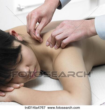 Chinese medicine oriental medicine/hand applying accupunture on patient's shoulder View Large Photo Image Stock Photo - Chinese medicine oriental medicine/hand applying accupunture on patient's shoulder. Fotosearch