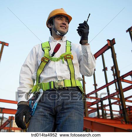 at a construction place, a worker talking on a radiotelegraph View Large Photo Image Stock Image - at a construction place, a worker talking on a radiotelegraph. Fotosearch