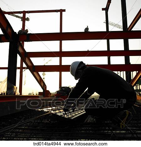 at a construction place, a worker's silhouette View Large Photo Image Picture - at a construction place, a worker's silhouette. Fotosearch