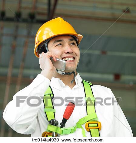 at a construction place, a worker's hand talking on the phone View Large Photo Image Stock Image - at a construction place, a worker's hand talking on the phone. Fotosearch