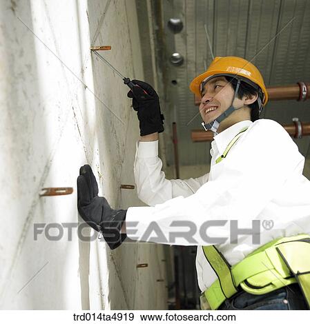 at a construction place, a working worker View Large Photo Image Stock Photo - at a construction place, a working worker. Fotosearch