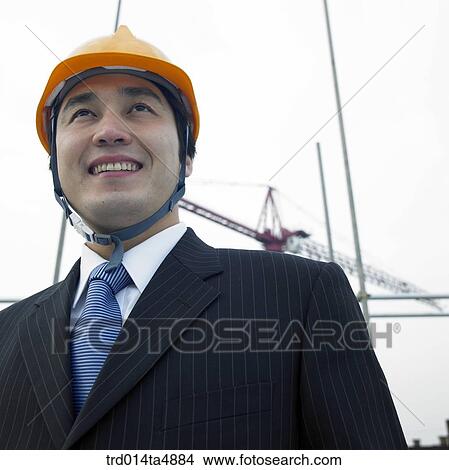 at a construction place, an architect looking at the workplace View Large Photo Image Picture - at a construction place, an architect looking at the workplace. Fotosearch