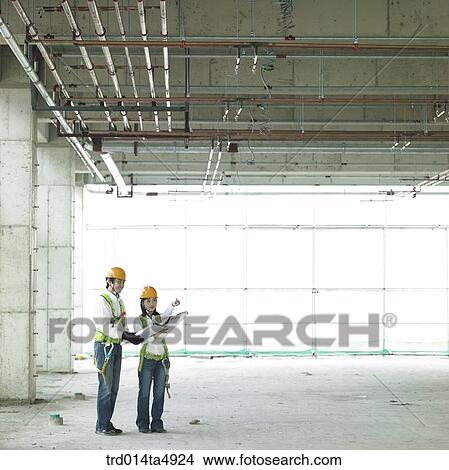 at a construction place, an architect looking around a workplace View Large Photo Image Picture - at a construction place, an architect looking around a workplace. Fotosearch
