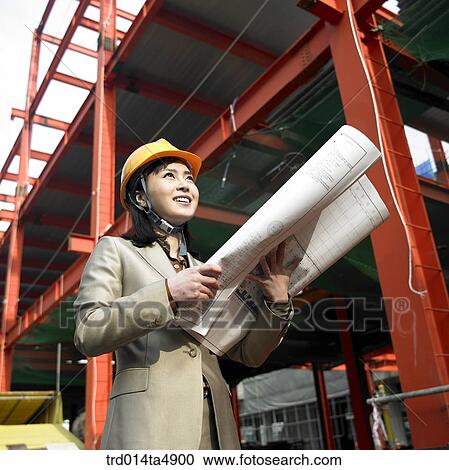 at a construction place, an architect looking at a plan and looking around the workplace View Large Photo Image Stock Image - at a construction place, an architect looking at a plan and looking around the workplace. Fotosearch