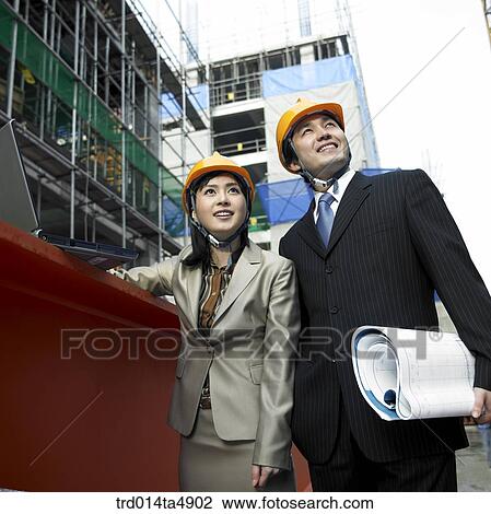 at a construction place, an architect looking around the workplace View Large Photo Image Stock Image - at a construction place, an architect looking around the workplace. Fotosearch