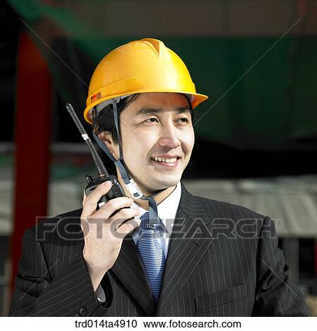 at a construction place, an architect holding a radiotelegraph and looking around a workplace View Large Photo Image Stock Image - at a construction place, an architect holding a radiotelegraph and looking around a workplace. Fotosearch
