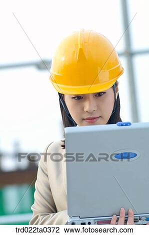 at a construction place, an architect working with a notebook View Large Photo Image Stock Image - at a construction place, an architect working with a notebook. Fotosearch