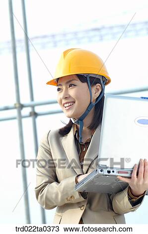 at a construction place, an architect working with a notebook View Large Photo Image Stock Image - at a construction place, an architect working with a notebook. Fotosearch