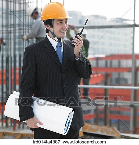 at a construction place, an architect talking with a radiotelegraph View Large Photo Image Stock Photo - at a construction place, an architect talking with a radiotelegraph. Fotosearch