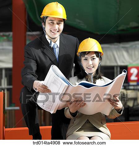 at a construction place, an architect looking at a plan View Large Photo Image Stock Photo - at a construction place, an architect looking at a plan. Fotosearch