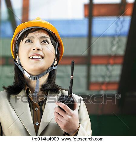 at a construction place, an architect holding a radiotelegraph and looking around a workplace View Large Photo Image Stock Photo - at a construction place, an architect holding a radiotelegraph and looking around a workplace. Fotosearch