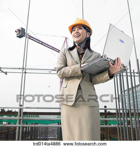 at a construction place, an architect working with a notebook View Large Photo Image Stock Photograph - at a construction place, an architect working with a notebook. Fotosearch