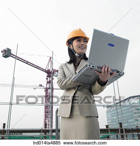 at a construction place, an architect working with a notebook View Large Photo Image Stock Photography - at a construction place, an architect working with a notebook. Fotosearch