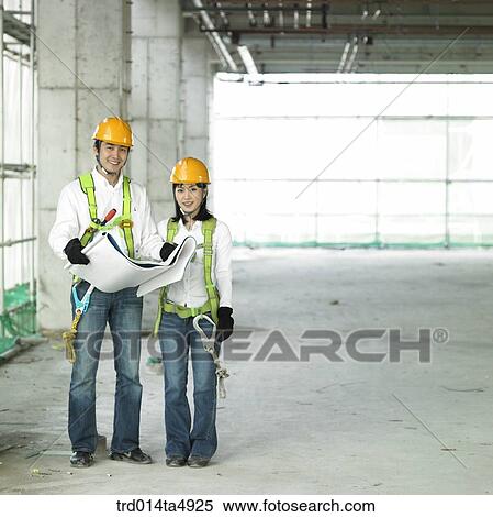 at a construction place, an architect looking at a plan and looking around a workplace View Large Photo Image Stock Photography - at a construction place, an architect looking at a plan and looking around a workplace. Fotosearch