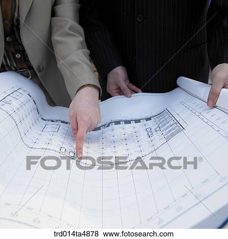 at a construction place, an architect's hand pointing at a plan View Large Photo Image Stock Photo - at a construction place, an architect's hand pointing at a plan. Fotosearch