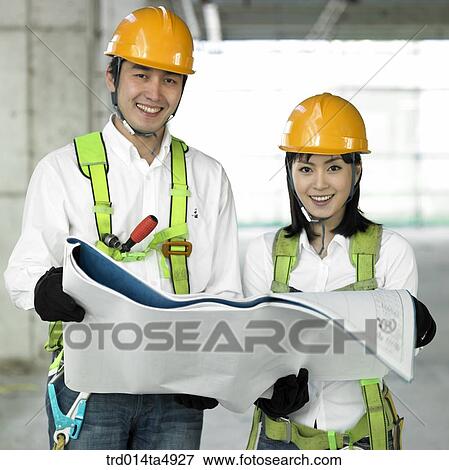 at a construction place, architect looking at a plan View Large Photo Image Stock Photo - at a construction place, architect looking at a plan. Fotosearch