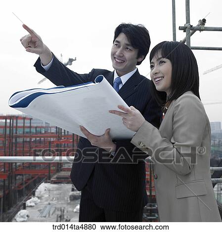 at a construction place, architects discussing about a plan View Large Photo Image Stock Image - at a construction place, architects discussing about a plan. Fotosearch