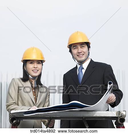 at a construction place, architects discussing about a plan View Large Photo Image Stock Image - at a construction place, architects discussing about a plan. Fotosearch