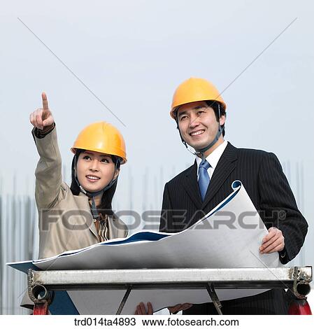 at a construction place, architects discussing about a plan View Large Photo Image Stock Image - at a construction place, architects discussing about a plan. Fotosearch
