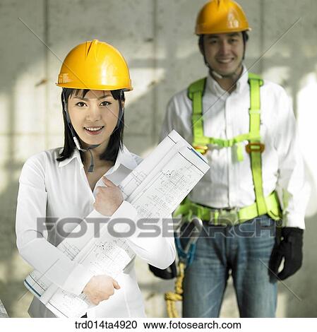 at a construction place, architects holding a plan View Large Photo Image Stock Image - at a construction place, architects holding a plan. Fotosearch