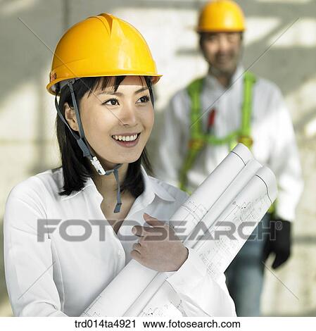 at a construction place, architects holding a plan View Large Photo Image Stock Image - at a construction place, architects holding a plan. Fotosearch
