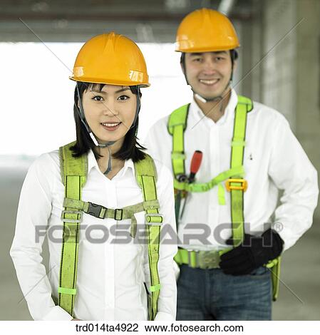 at a construction place, architects with safey equipment View Large Photo Image Stock Image - at a construction place, architects with safey equipment. Fotosearch