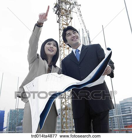 at a construction place, architects discussing about a plan View Large Photo Image Stock Photo - at a construction place, architects discussing about a plan. Fotosearch