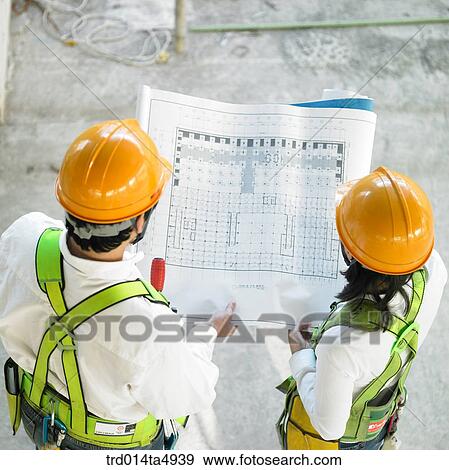 at a construction place, architects looking at a plan View Large Photo Image Stock Photo - at a construction place, architects looking at a plan. Fotosearch