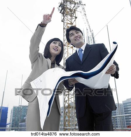 at a construction place, architects discussing about a plan View Large Photo Image Stock Photograph - at a construction place, architects discussing about a plan. Fotosearch