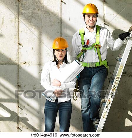 at a construction place, architects holding a plan View Large Photo Image Stock Photograph - at a construction place, architects holding a plan. Fotosearch