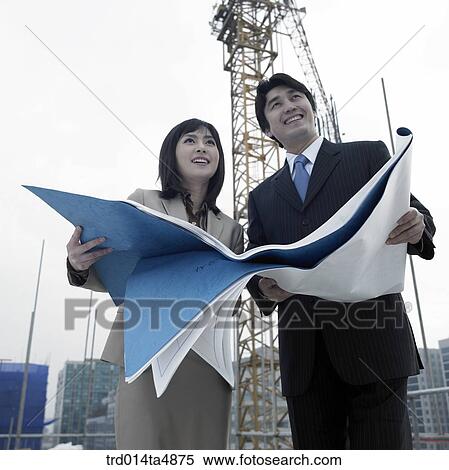 at a construction place, architects looking at a plan View Large Photo Image Stock Photography - at a construction place, architects looking at a plan. Fotosearch