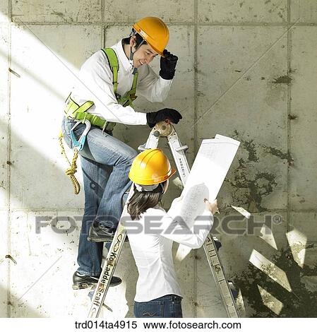 at a construction place, architects looking at a plan View Large Photo Image Stock Photography - at a construction place, architects looking at a plan. Fotosearch