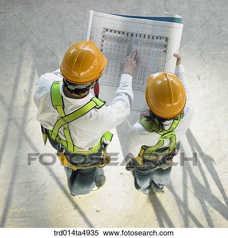 at a construction place, architects looking at a plan View Large Photo Image Stock Photography - at a construction place, architects looking at a plan. Fotosearch
