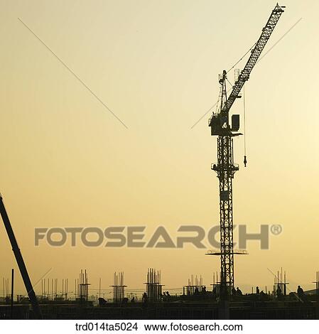 at a construction place, a construction machinery with the glow of the setting sun View Large Photo Image Picture - at a construction place, a construction machinery with the glow of the setting sun. Fotosearch