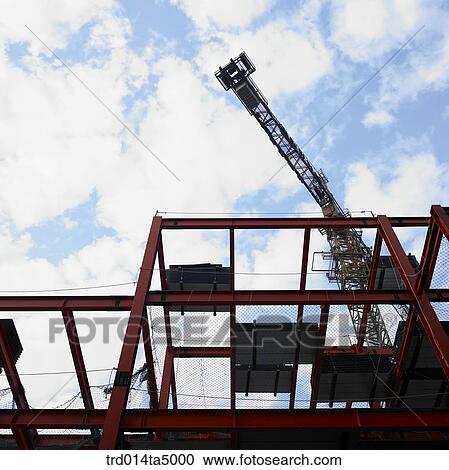at a construction place, a crane and construction equipments View Large Photo Image Stock Image - at a construction place, a crane and construction equipments. Fotosearch