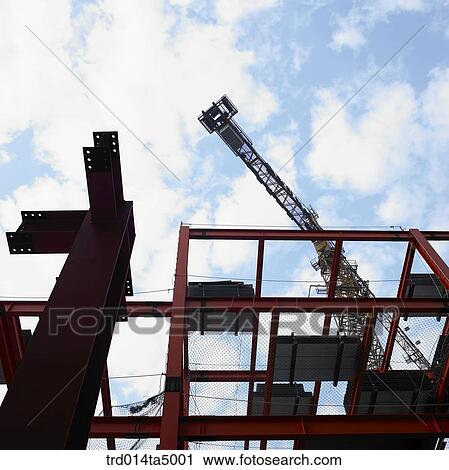 at a construction place, a crane and construction equipments View Large Photo Image Stock Image - at a construction place, a crane and construction equipments. Fotosearch