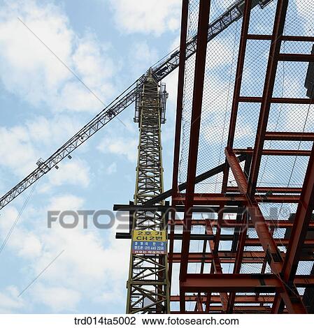 at a construction place, a crane and construction equipments View Large Photo Image Stock Image - at a construction place, a crane and construction equipments. Fotosearch