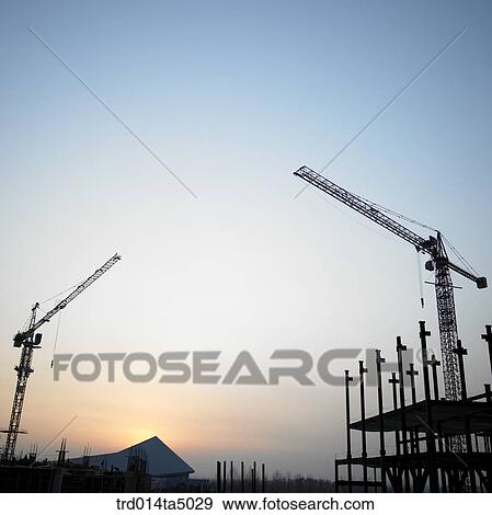 at a construction place, a crane and construction equipments View Large Photo Image Stock Photo - at a construction place, a crane and construction equipments. Fotosearch