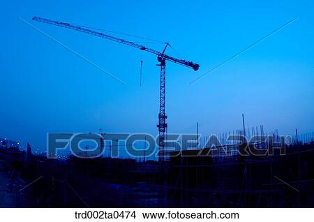at a construction place, a crane in the evening View Large Photo Image Picture - at a construction place, a crane in the evening. Fotosearch