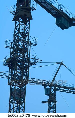 Stock Photography - at a construction place, a crane in the evening. Fotosearch